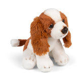 Plush toy dog with brown and white fur on a white background