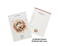 Golden Cream painted cockapoo on a weekly planner pad